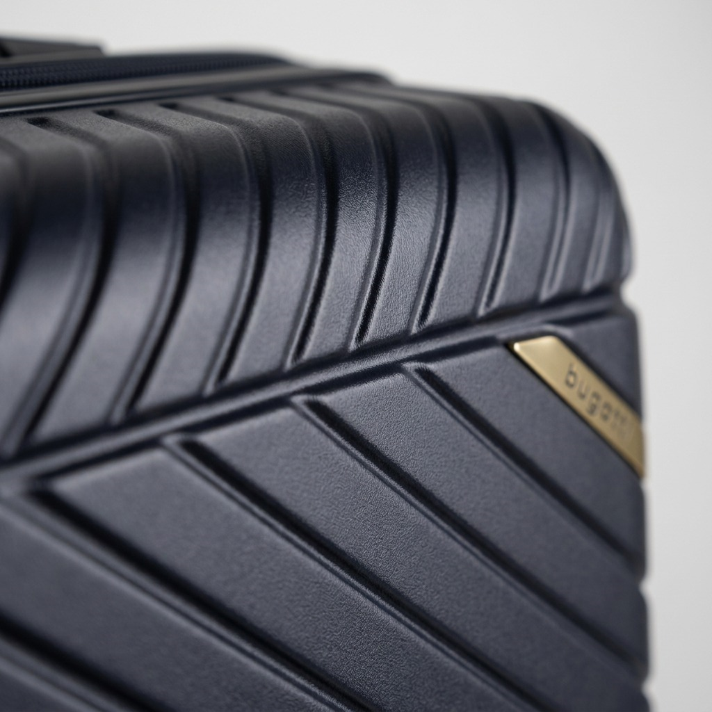 Macro detail of the navy polycarbonate shell on a Bugatti Oslo luggage, showing textured ridges.