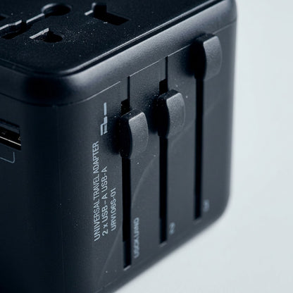 Macro close-up of the Verbatim UTA-01 Universal Travel Adapter showing matte black slider controls.