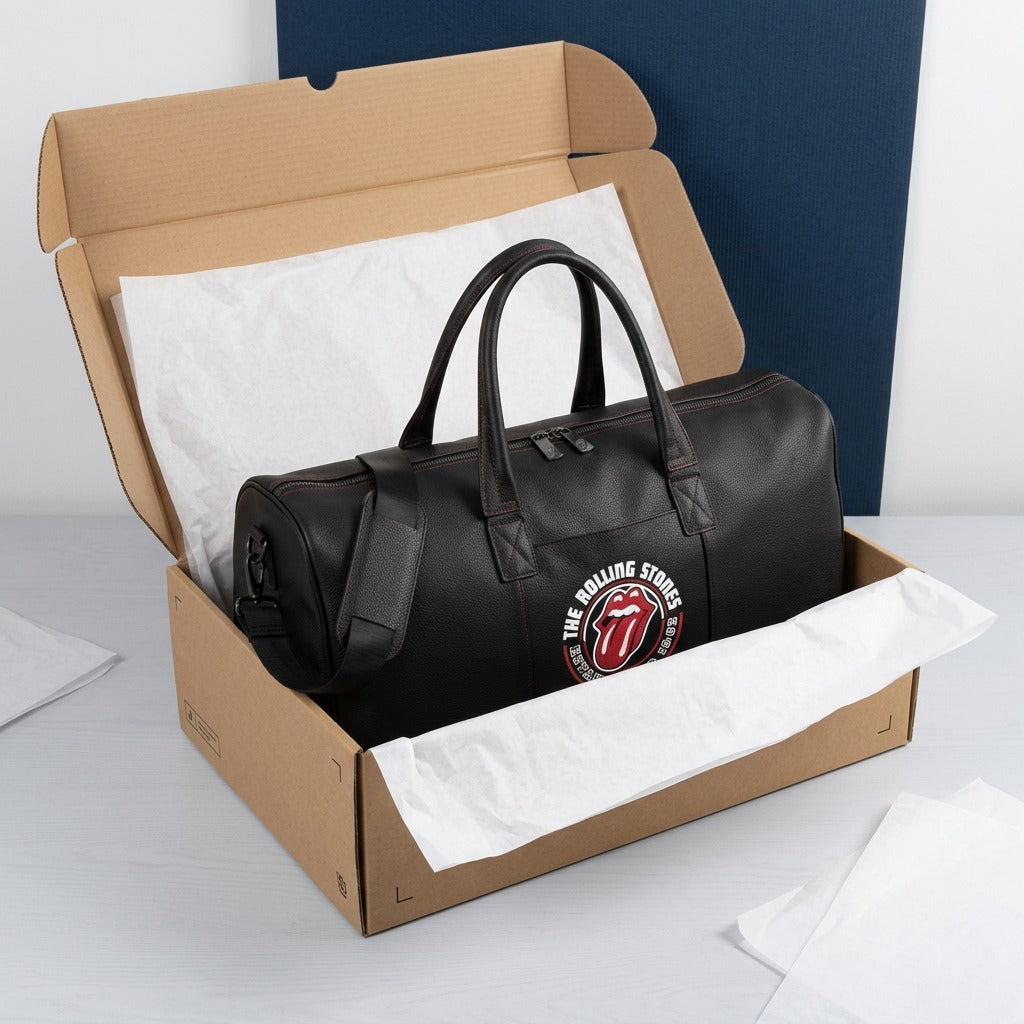 Bugatti The Rolling Stones Watts Leather Duffle Bag in a shipping box with white tissue paper.