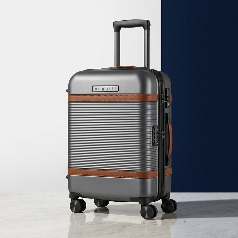 Bugatti Wellington 21-inch carry-on in pewter grey with brown vegan leather trim and spinner wheels.