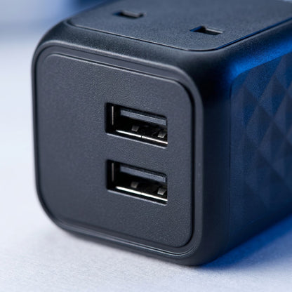 Macro view of the Verbatim Universal Travel Adapter UTA-10 showing dual USB-A ports and matte finish.