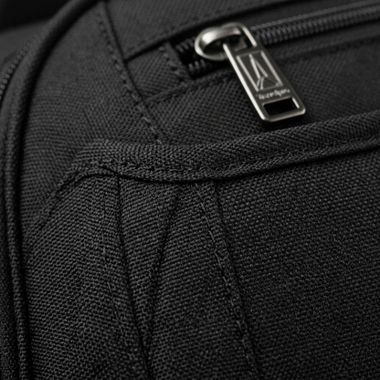 Macro detail of black Travelpro Maxlite fabric texture, durable stitching, and metal zipper pull.