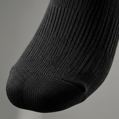 Macro detail of black Austin House compression socks showing the reinforced toe and rib knit texture.